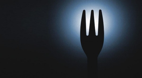 Dining in the dark Dans Le Noir fork in front of a light